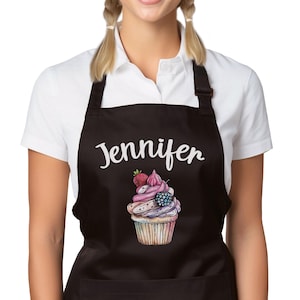 May include: Black apron with a white cupcake design and the name Jennifer printed on it.