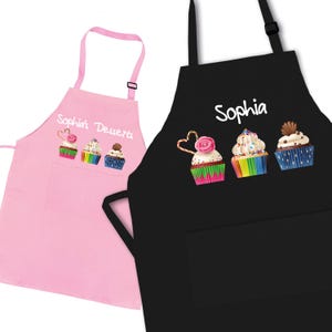 May include: Two aprons with cupcake designs. One pink apron says "Sophia's Desserts" and the other black apron says "Sophia".