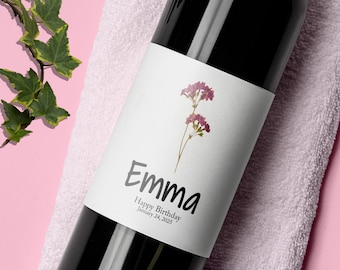 May include: A white wine bottle label with a floral design and the text "Emma Happy Birthday January 24, 2025".