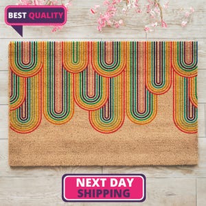 May include: A coir doormat with a colorful rainbow design. The rainbow is made up of multiple arches of red, orange, yellow, green, blue, indigo, and violet. The doormat is on a light wood floor.