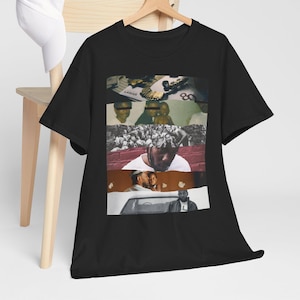 May include: Black t-shirt with a collage of images featuring a man in a car, a crowd of people, and a close-up of a man's face. The text "LAMAR" is visible in the collage.