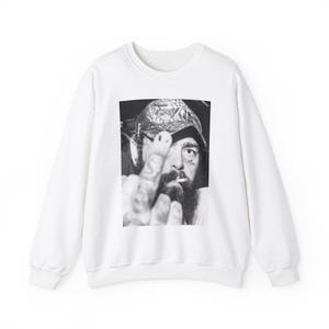 May include: White sweatshirt with a black and white photo of a person wearing a hat and giving the middle finger. The person has a beard and tattoos.