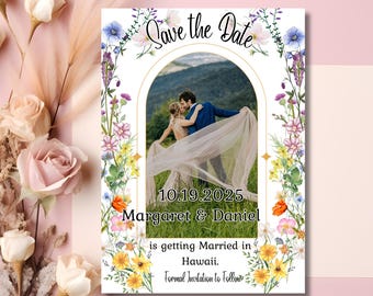 May include: Save the Date card with a floral border and a photo of a couple in a field. The text reads "Save the Date 10.19.2025 Margaret & Daniel is getting Married in Hawaii. Formal Invitation to Follow."