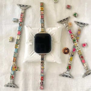 Puede incluir: Tres correas para Apple Watch con abalorios coloridos. Las correas son plateadas y tienen una variedad de abalorios, incluyendo flores, corazones y animales. Los abalorios están unidos a las correas con pequeños anillos metálicos. Las correas están sobre una superficie blanca. BandSwap BandSwap BandSwap
