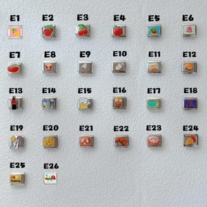 May include: A collection of silver-toned charms with colorful food and drink designs. Charms include a pineapple, strawberry, cherries, apple, watermelon, peach, tomato, french fries, ice cream, and a hamburger.