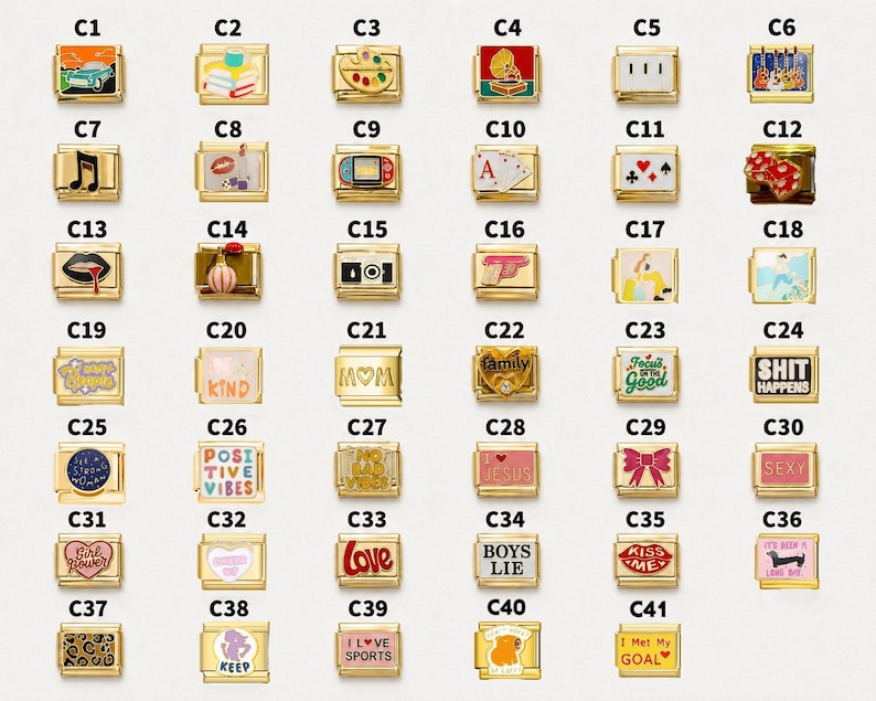 May include: A collection of forty-one rectangular gold-tone modular bracelet links, each featuring a unique enamel graphic or text design. The designs include icons like cars, books, musical notes, playing cards, hearts, and various phrases like SHIT HAPPENS.