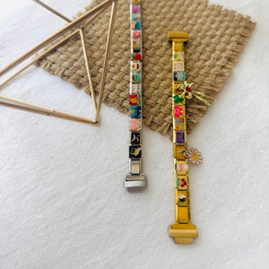 May include: Two charm bracelets with colorful enamel charms. The bracelet on the left is silver with a silver clasp. The bracelet on the right is gold with a gold clasp. Both bracelets have a variety of charms, including hearts, stars, flowers, and animals.