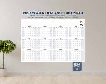 May include: A 2027 year at a glance wall calendar featuring a grid layout for twelve months, with sections for goals, notes, and plans. The text reads 2027 YEAR AT A GLANCE CALENDAR, 24x18, 36x24, 48x36, PRINTED ON THICK MATTE PAPER, and BONUS PRINTABLE SET INCLUDED.