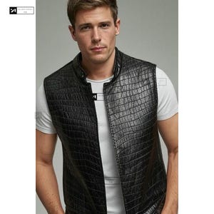 May include: A black leather waistcoat with a crocodile-embossed pattern. The waistcoat has a zip fastening and a stand-up collar.