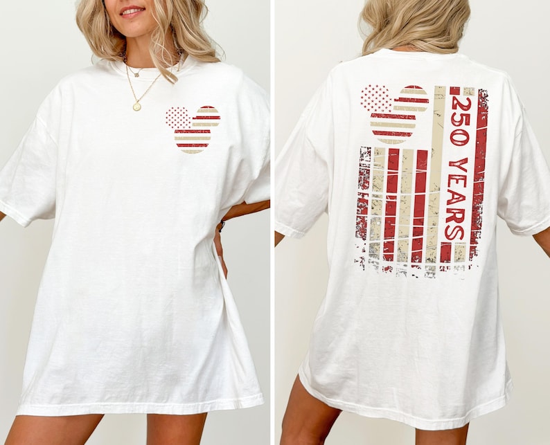 May include: White t-shirt with a Mickey Mouse-themed design in red and beige. The front has a small graphic, and the back features a larger design with the text "250 YEARS".