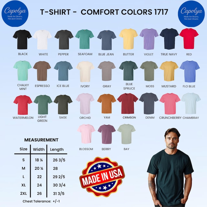 Op de afbeelding: Een selectie Comfort Colors 1717 T-shirts in diverse kleuren, waaronder zwart, wit en rood. De afbeelding toont een maattabel met afmetingen in inches en een "Made in USA"-embleem. Een man poseert in een donkergroen t-shirt.
