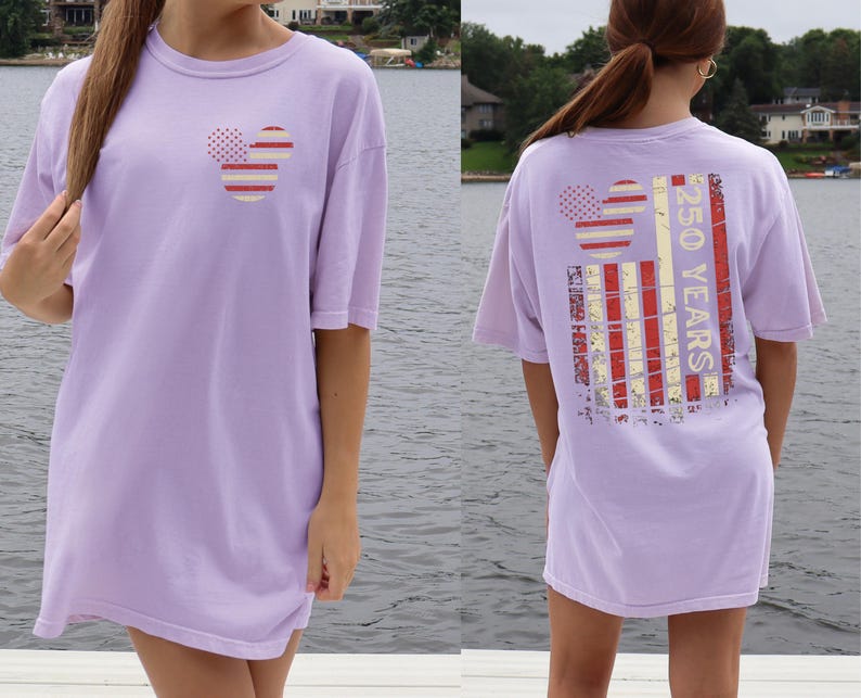 May include: A lilac t-shirt with a Mickey Mouse-style design on the front and back. The design incorporates red and white stripes and dots. The back of the shirt displays the text "250 YEARS" in a vertical arrangement.