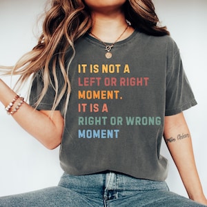 May include: A gray t-shirt with the text "IT IS NOT A LEFT OR RIGHT MOMENT. IT IS A RIGHT OR WRONG MOMENT" printed in rainbow colors.