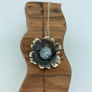 Silver flower pendant with dendrite opal center