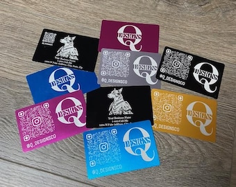 May include: A collection of eight business cards with a variety of colours and designs. Each card features a stylised letter Q with the word "DESIGNS" and a QR code. The cards are made of metal and have a brushed finish.