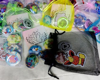 May include: Assortment of colorful buttons in various designs, including cartoon characters, geometric shapes, and floral patterns. The buttons are packaged in small, clear bags with a black drawstring bag containing additional buttons.