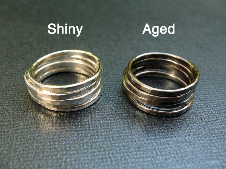 May include: Two silver rings, one shiny and one aged, with a hammered texture. The rings are stacked on top of each other.