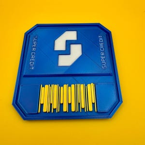 May include: A blue plastic card with the text "SUPER CREDIT" on both sides. The card has a white stylized letter "S" in the centre and a yellow barcode.