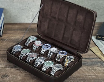 May include: A brown leather watch case with a zipper, open to reveal twelve wristwatches with silver and gold bands and various colored watch faces. The watches are displayed on a brown suede-like interior. The text "GEMHUNTERCRAFTS" is at the bottom.