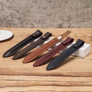 May include: Five leather cases for Apple Pencil, in brown, black, and dark red. The cases are made of high-quality leather and have a simple, elegant design.