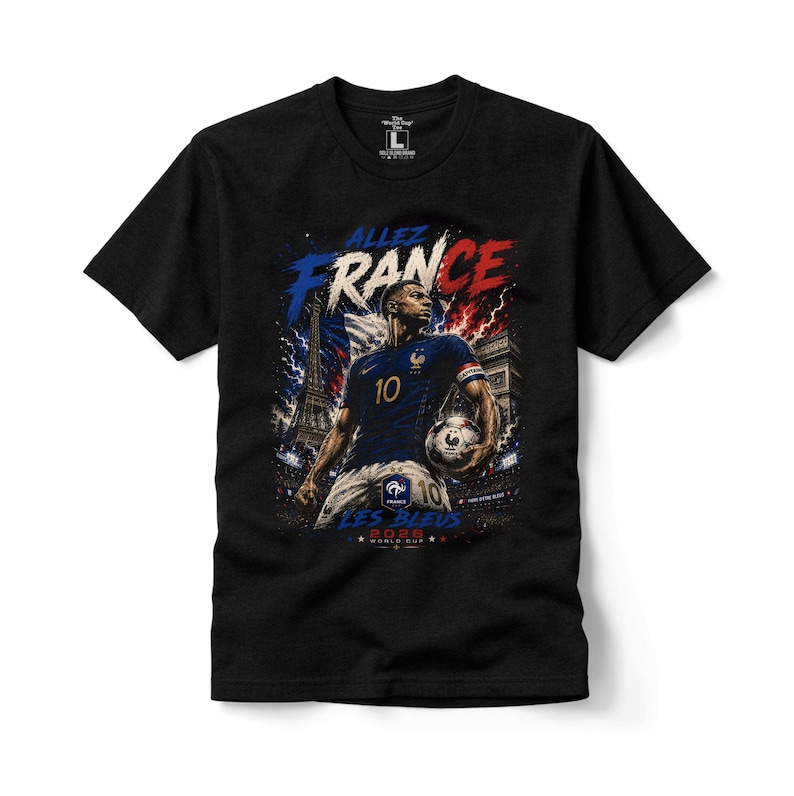 May include: A black short-sleeved t-shirt featuring a graphic of a football player in a blue jersey with the number 10, holding a football. The design includes the text "ALLEZ FRANCE", "LES BLEUS", and "2026 WORLD CUP" with the Eiffel Tower.