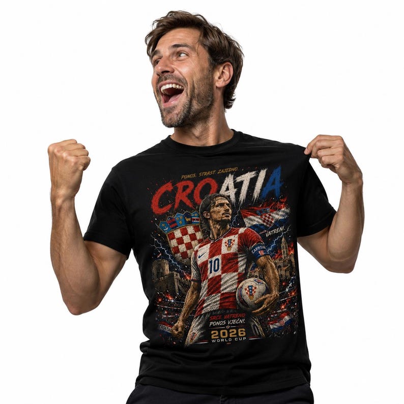May include: A black t-shirt featuring a graphic print of a football player in a red and white chequered jersey with the number 10. The design includes the text "CROATIA", "PONOS, STRAST, ZAJEDNO", "VATRENI", "SRCE, VATRENO, PONOS VJEČNI!", and "2026 WORLD CUP".