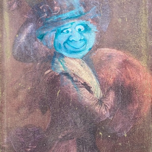 May include: An antique painting featuring a figure with a blue face and hat. The figure is wearing a brown coat and a dress. The painting has a vintage, aged appearance with visible brushstrokes and a muted color palette.