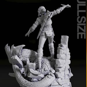 May include: A detailed, gray figurine of a woman in a combat pose, standing atop a rocky, dragon-like structure. She is dressed in fitted pants, a jacket, and boots, with a sword at her side. The word "FULLSIZE" is printed vertically on the right.