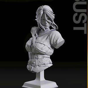 May include: A detailed, grayscale bust sculpture of a woman with long, flowing hair. The bust features a detailed bodice with a belt and square buckles, mounted on a square pedestal. The word "BUST" is printed vertically on the right side.
