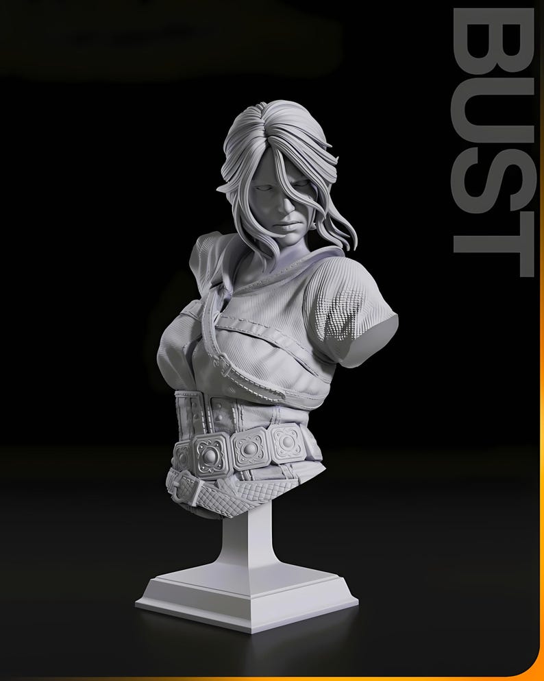 May include: A detailed, grayscale bust sculpture of a woman with long, flowing hair. The bust features a detailed bodice with a belt and square buckles, mounted on a square pedestal. The word "BUST" is printed vertically on the right side.