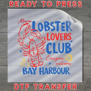 May include: A DTF transfer featuring a red lobster illustration and the words "Maine Lobster Lovers Club" in blue and red. The design includes the text "Bay Harbour" and "Everyone welcome."