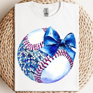a t - shirt with a baseball and a bow on it