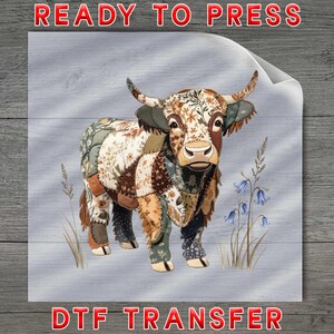May include: A colorful patchwork Highland cow illustration. The cow features a mix of floral and patterned fabrics in shades of brown, green, and cream. The words "READY TO PRESS" and "DTF TRANSFER" are in red.