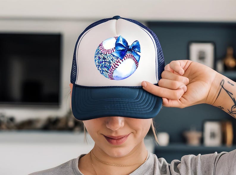 a woman holding a baseball cap with a bow on it