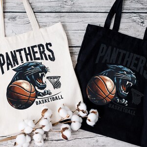two black and white bags with panther's on them