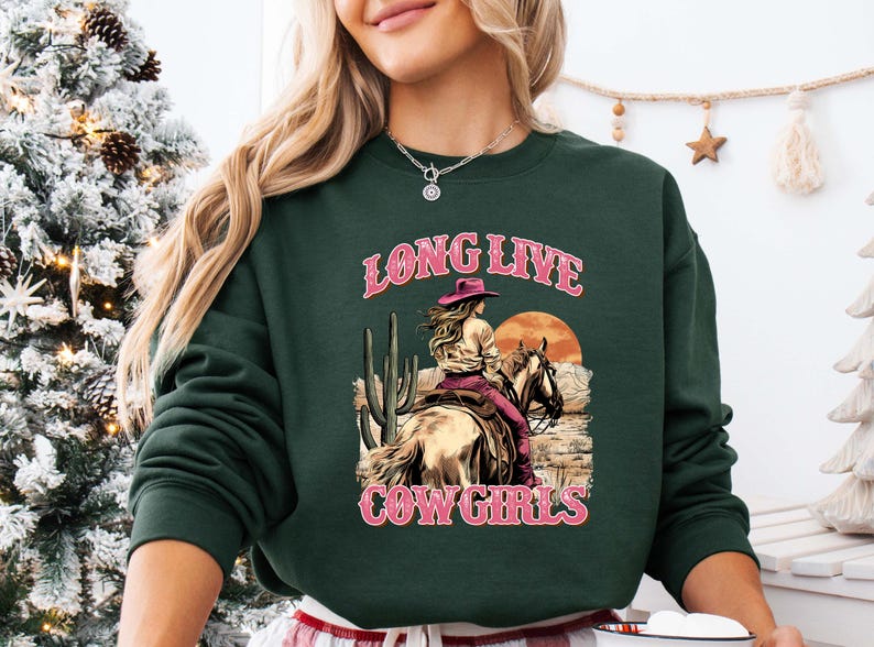 a woman wearing a long live cowgirl sweatshirt