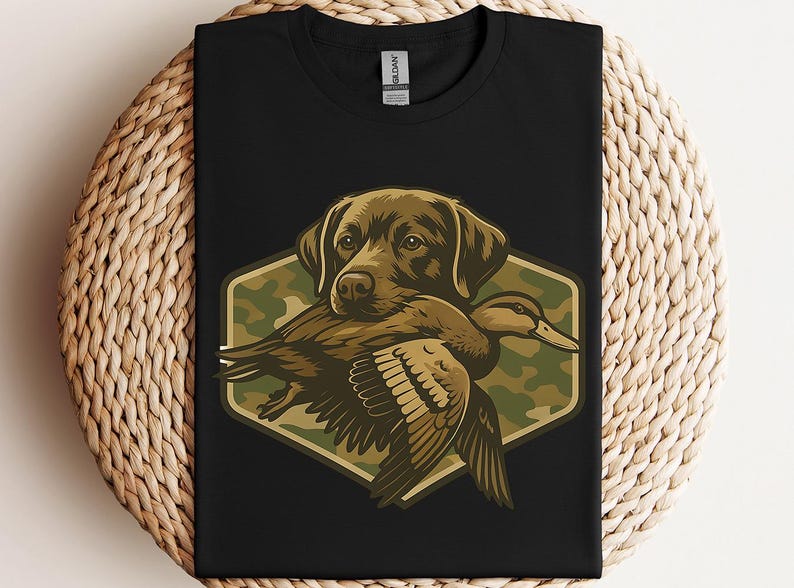 A black t-shirt with a graphic design depicting a dog holding a duck in its mouth.