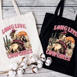 two long live cowgirls bags sitting on a table
