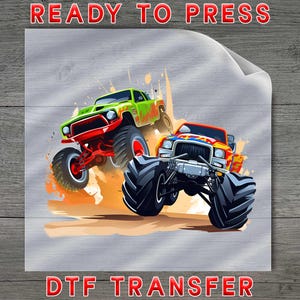 May include: A DTF transfer sheet featuring a graphic illustration of a bright green monster truck and a red monster truck with large black tires, kicking up orange and yellow dust. The text READY TO PRESS and DTF TRANSFER is printed in red.