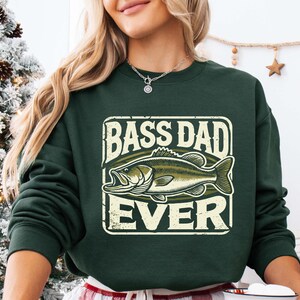 a woman wearing a green bass dad sweatshirt