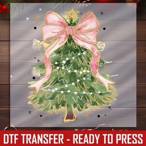 a picture of a christmas tree with a pink bow