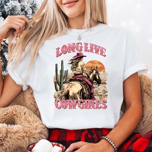 a woman wearing a long live cowgirl t - shirt