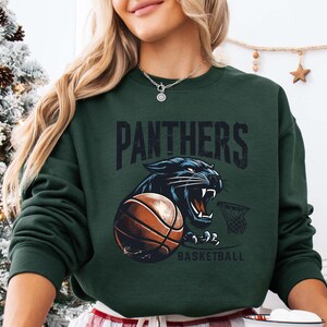 a woman wearing a sweatshirt with a panther on it