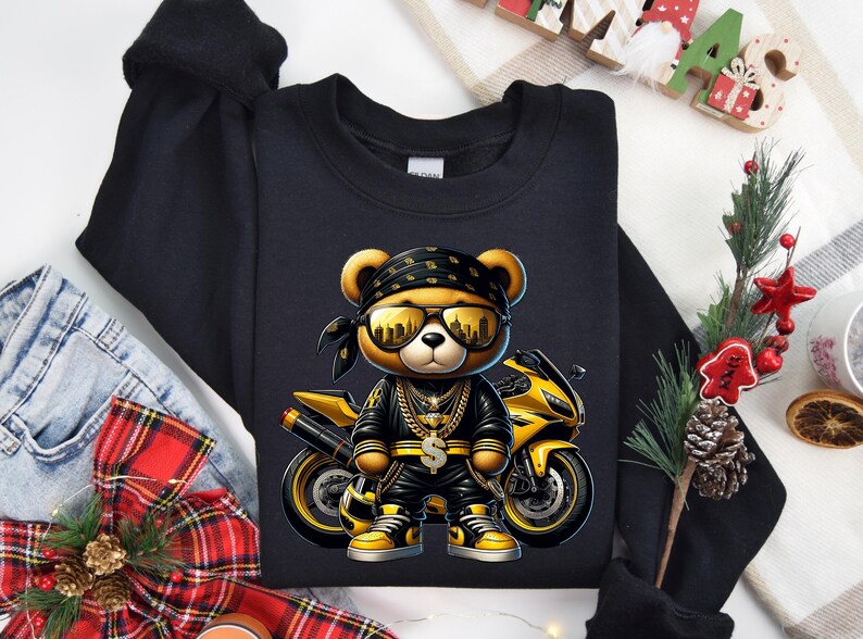 a black shirt with a picture of a bear riding a motorcycle