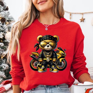 a woman wearing a red sweater with a teddy bear on it
