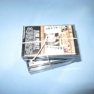 May include: A collection of Elvis Presley cassette tapes, secured with an elastic band. The album cover displays a photograph of Elvis and the text "ELVIS FOR EVERYONE!" on a black background.
