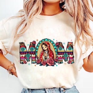 May include: Cream-colored sweatshirt with the word "MOM" in a colorful, patterned design. The "O" features an illustration of a woman in a red veil, surrounded by roses. The letters have turquoise and pink accents.