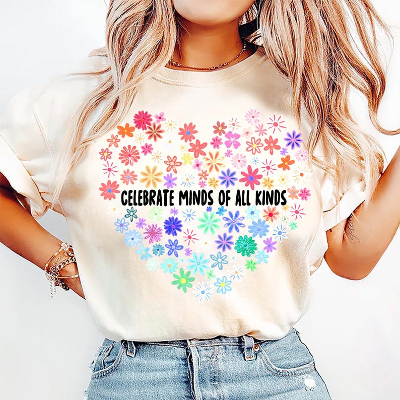 May include: A white t-shirt with a rainbow heart design and the text "Celebrate Minds of All Kinds".