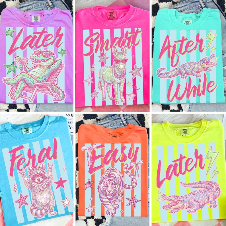 Pode incluir: Uma cole&ccedil;&atilde;o de camisetas coloridas com v&aacute;rios designs. Cada camisa apresenta um gr&aacute;fico de animal diferente, como um jacar&eacute;, um burro, um guaxinim e um tigre, junto com textos como "Later" e "Smart". As camisas t&ecirc;m um fundo listrado.