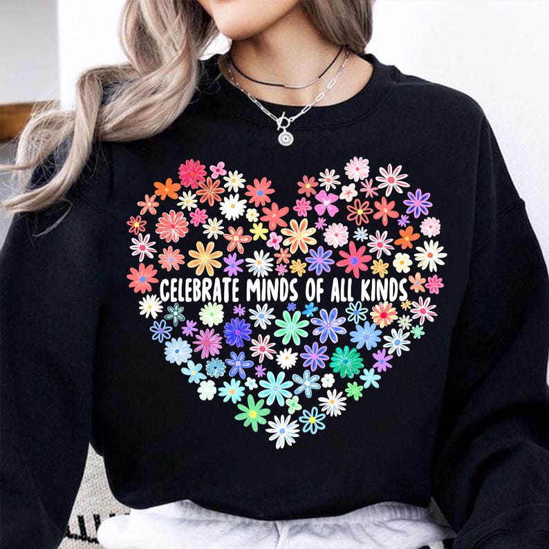 May include: Black sweatshirt with a rainbow heart made of flowers and the text "Celebrate Minds of All Kinds".